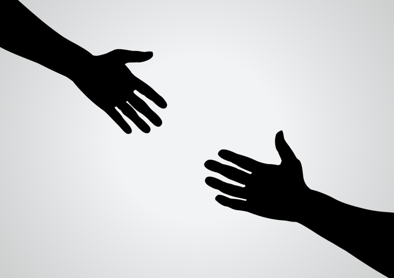 shadowed hands reaching out to each other_800x566